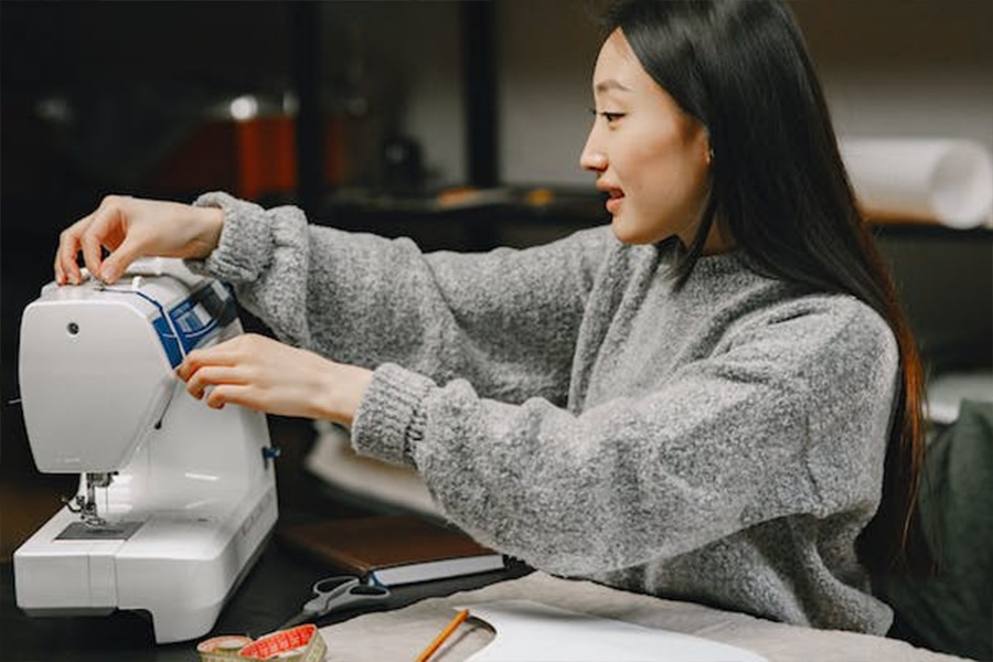 Woman setting up a sewing machine