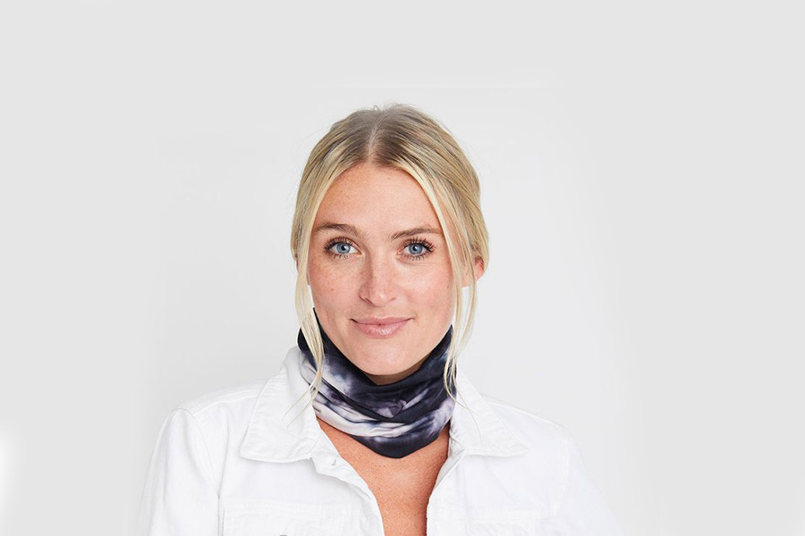 Woman smiling in a blue and white neck gaiter