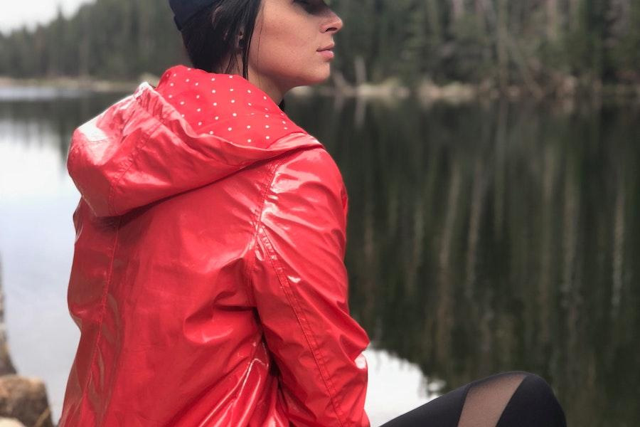 woman wearing a weatherproof jacket by a lake