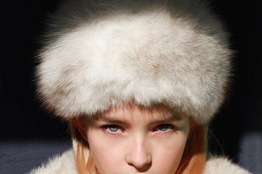 Woman wearing a white fur hat