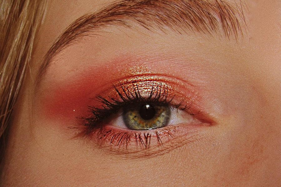 Woman wearing red and gold eyeshadow