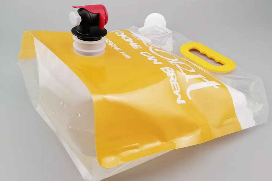 Yellow drink bag with nozzle on front and a handle