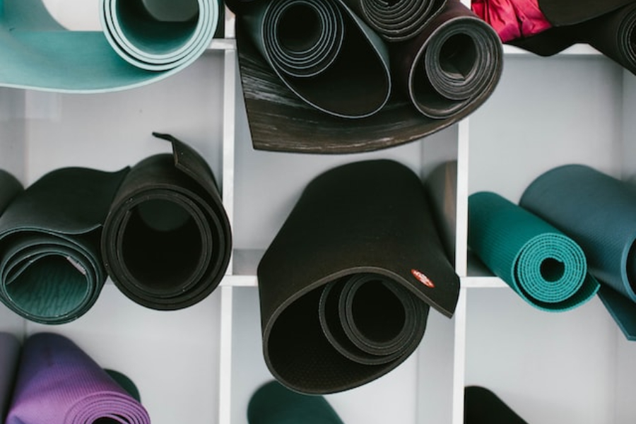 A collection of rubber yoga mats in different colors