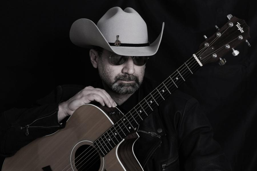 a country musician wearing a black cowboy hat