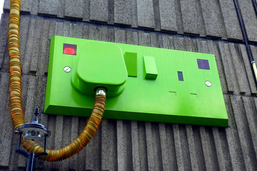 A green charging spot on a gray wall