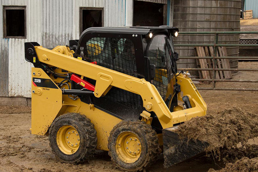 a skid steer with front loader busy moving earth