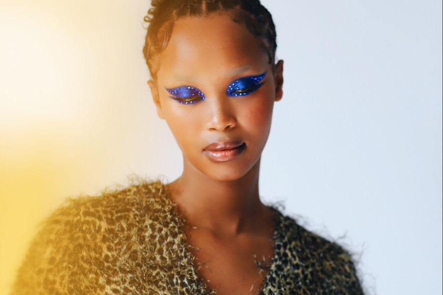 African American woman with bleached brows and electric blue eyeshadow