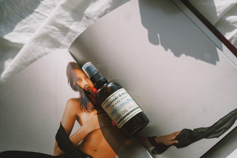 Body oil on a sensual magazine