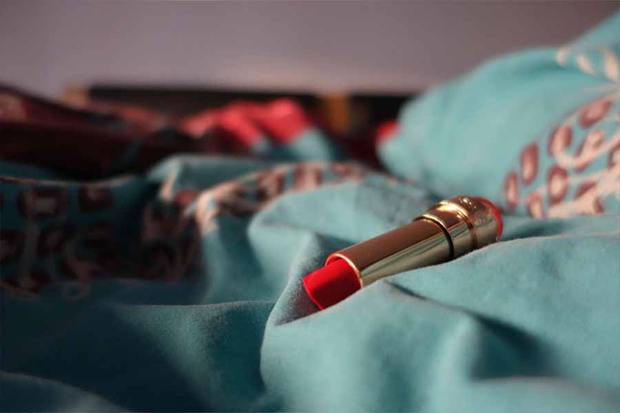 Bright red lipstick on a light-blue blanket