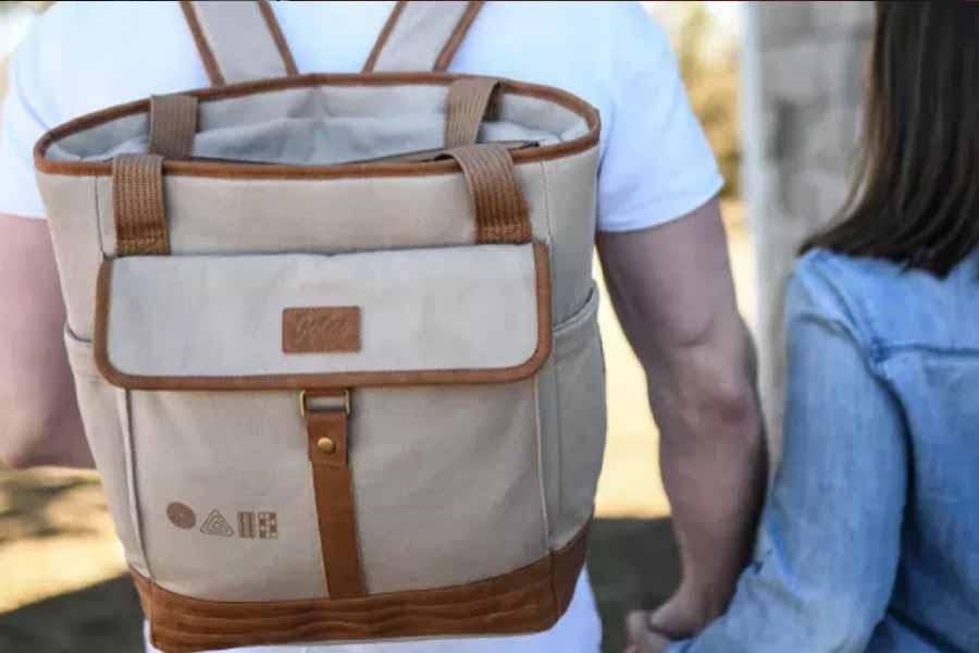 Cream and brown cooler backpack being worn by a man
