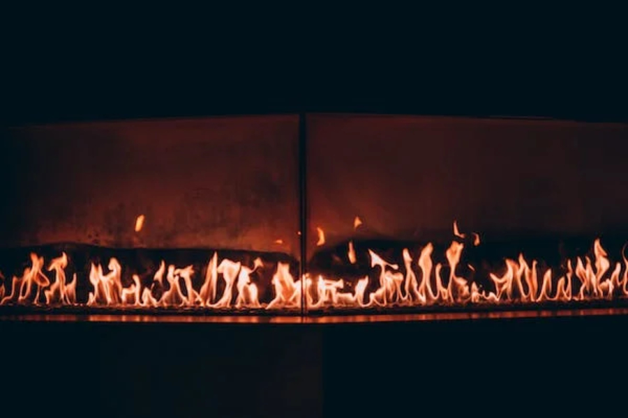 Customizable wall-mounted electric fireplace in a dark room