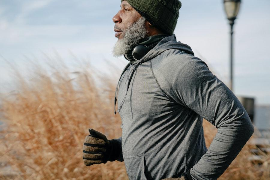 Dark-skinned man running in comfortable sportswear
