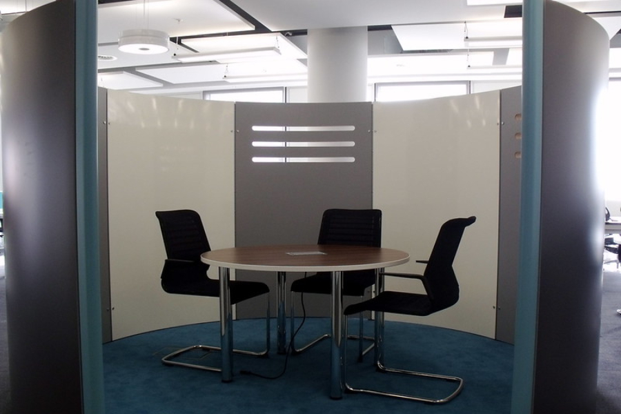 enclosed meeting office pods with three empty chairs