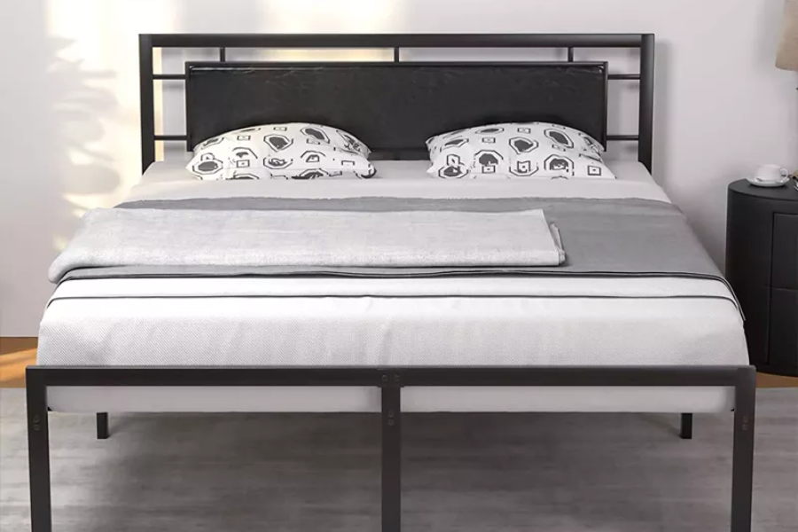 Grey rug on top of a black metal bed frame