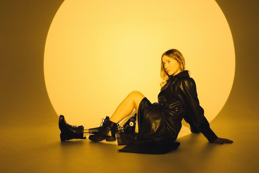 Lady posing while wearing a black leather outfit