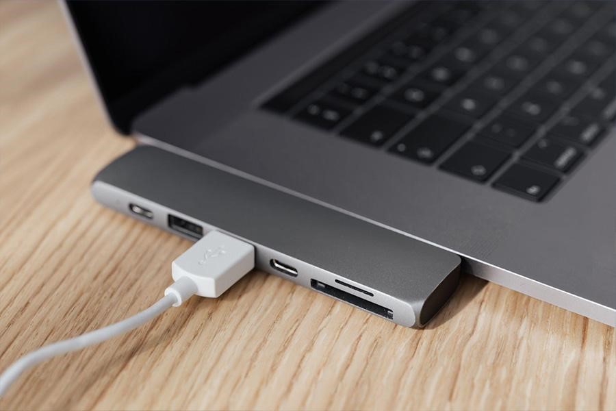 Laptop with universal adaptor and a USB cable connected