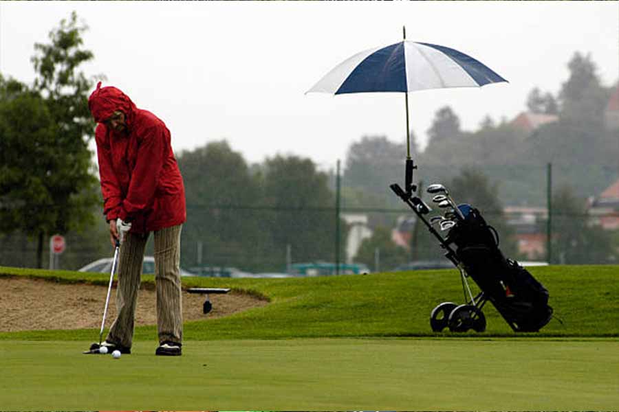 Man playing golf in the rain with waterproof golf bag
