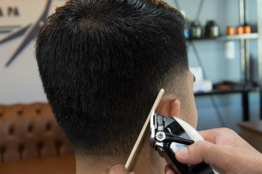 Man using a regular clipper for a haircut