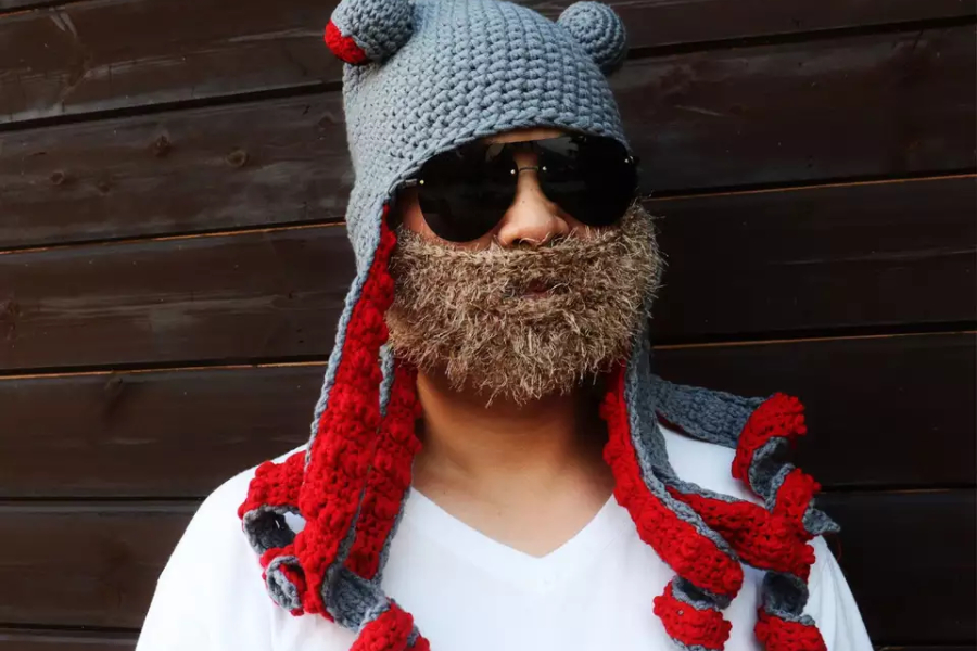 Man wearing a crochet hat in the shape of octopus