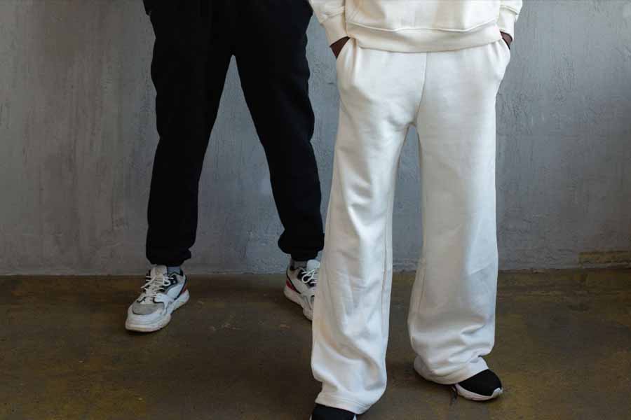 Man wearing white baggy pants with hands in pocket