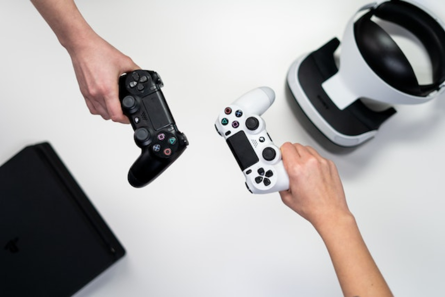 Person Holding White and Black Game Controller