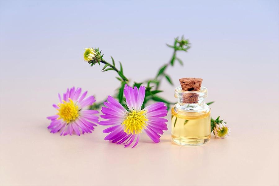 Small perfume next to flowers