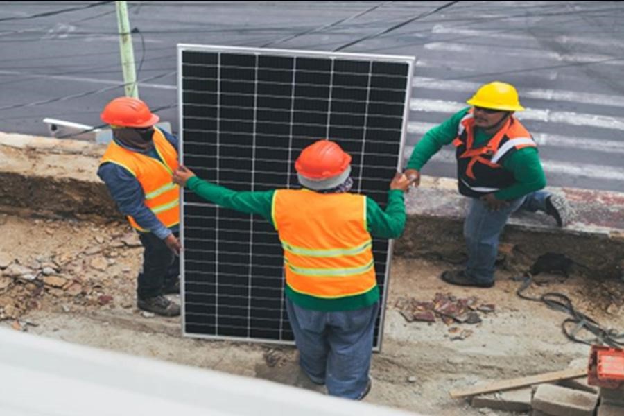 Solar installers holding a solar panel