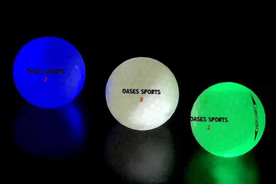 Three different colors of glow-in-the-dark golf balls