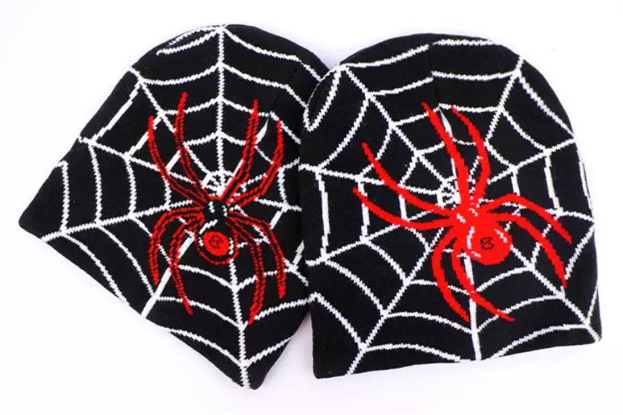 Two black beanie hats with spider and web printed on