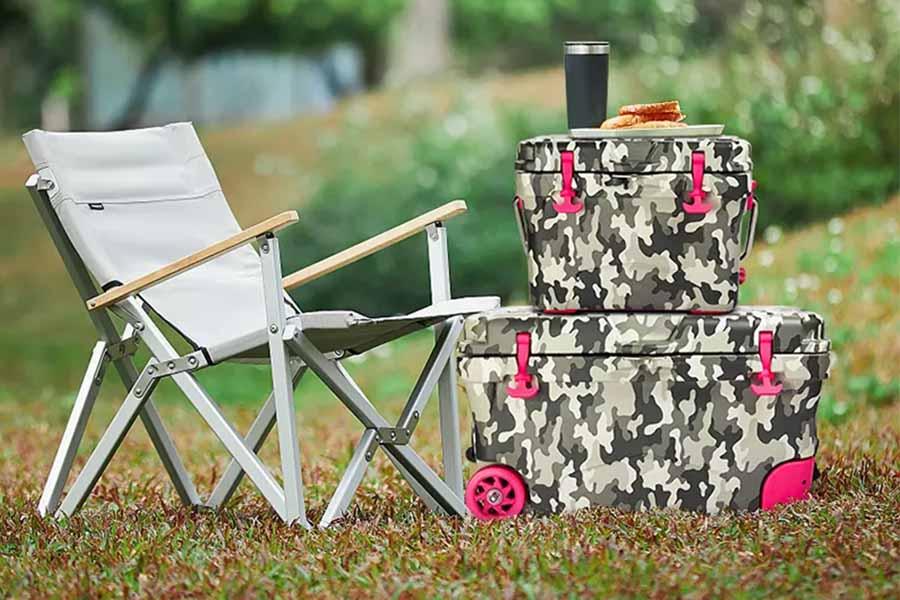 Two different sized camouflage cooler boxes with pink wheels
