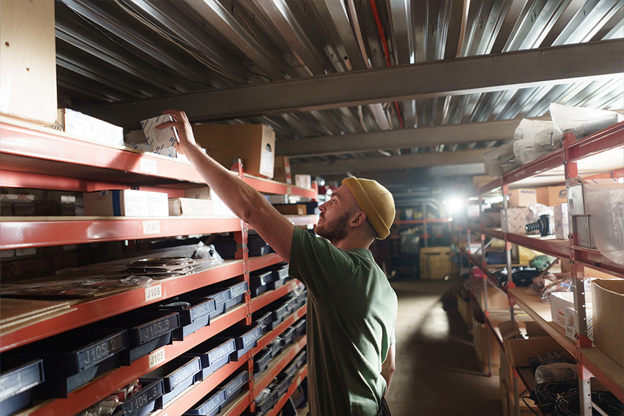 Warehouse worker taking inventory of spare parts