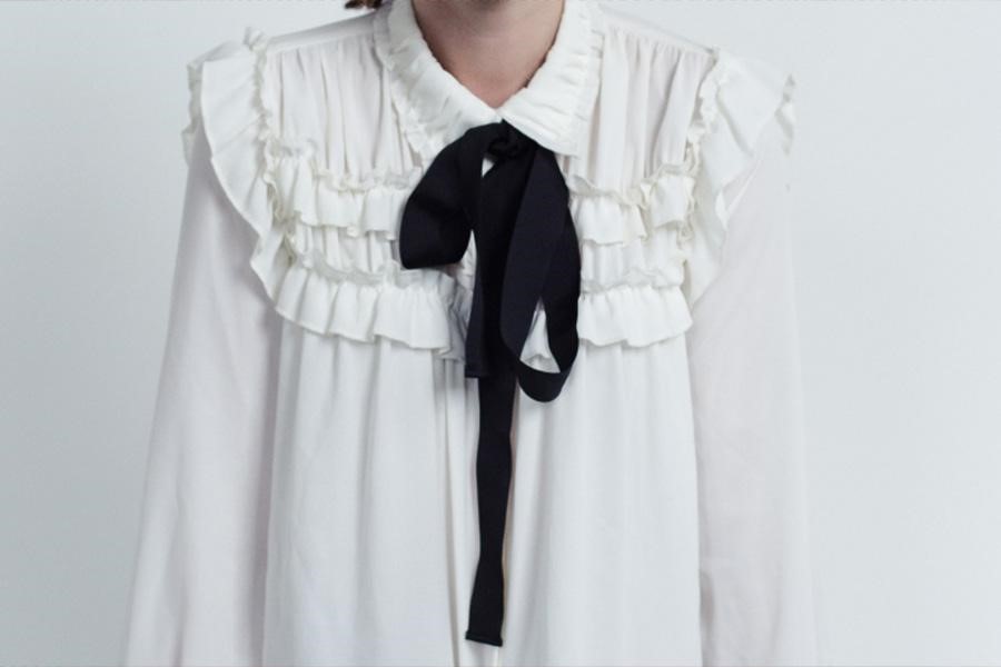 White frilly blouse with black bow