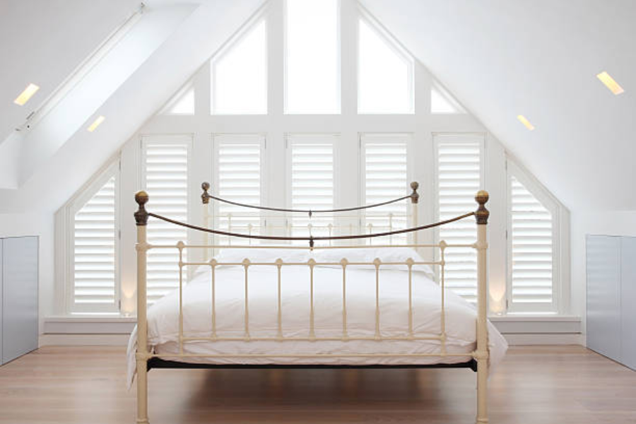 White painted metal bed frame on hardwood floor