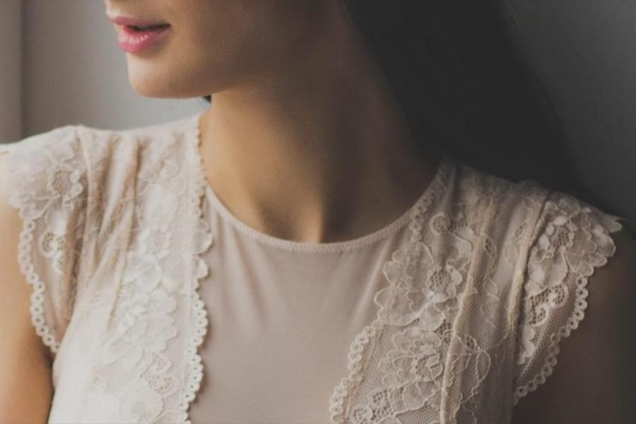 Woman in white shirt with lace trim