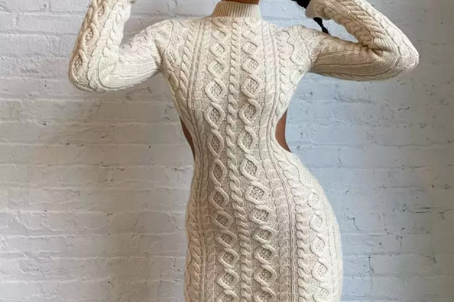 Woman wearing a cream mini sweater dress inside