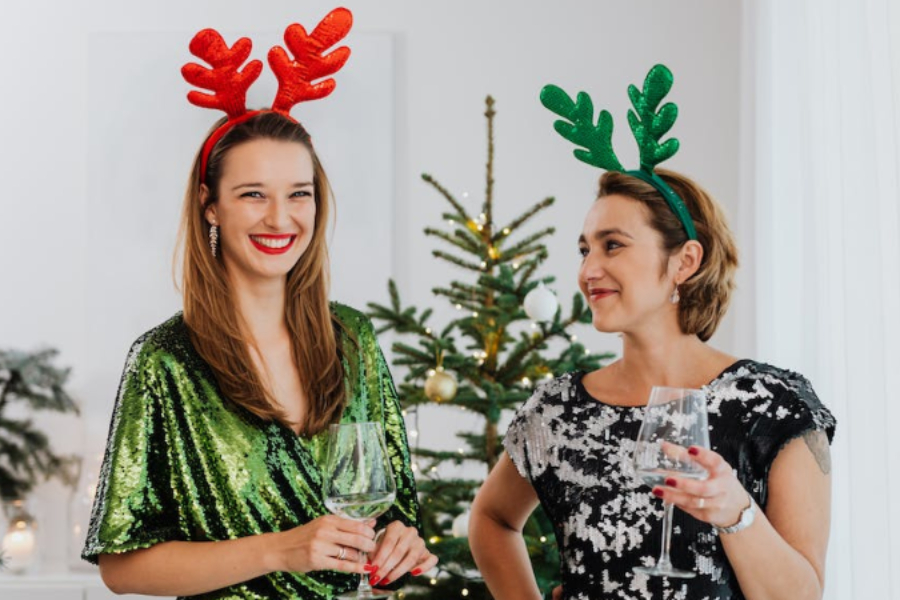 Women wearing reindeer antler headbands for a christmas party