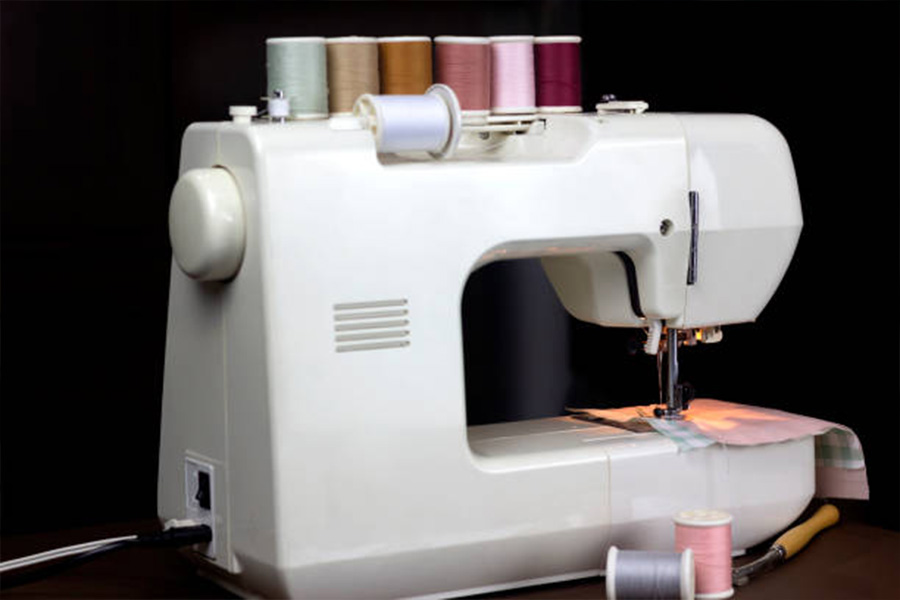 A close-up of a white sewing machine