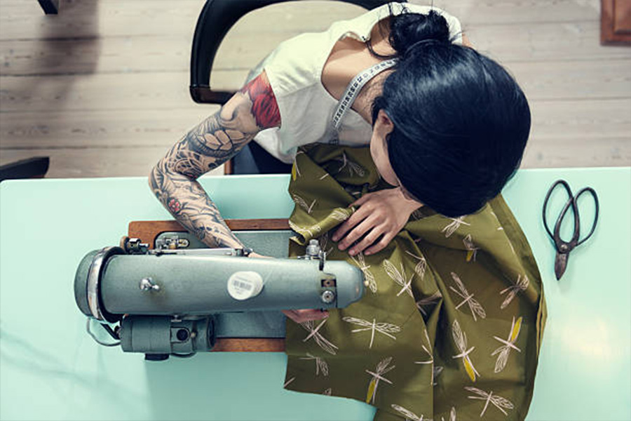 A female dressmaker working with a sewing machine