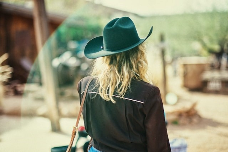 A woman wearing a black cowboy hat