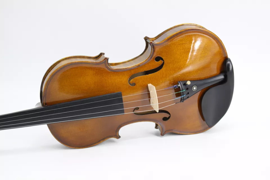 Classic violin with dark wood neck sitting on its side