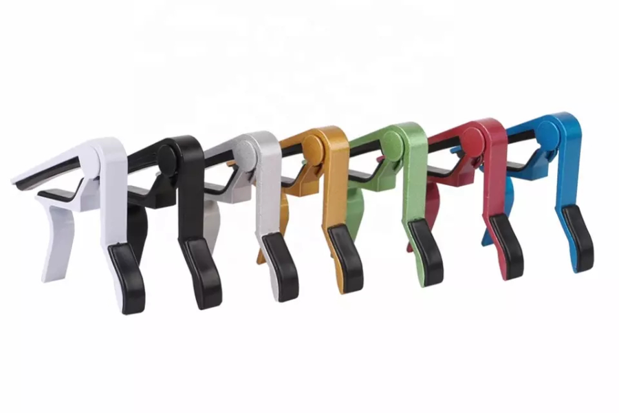 Seven colors of guitar clamps lined up in a row