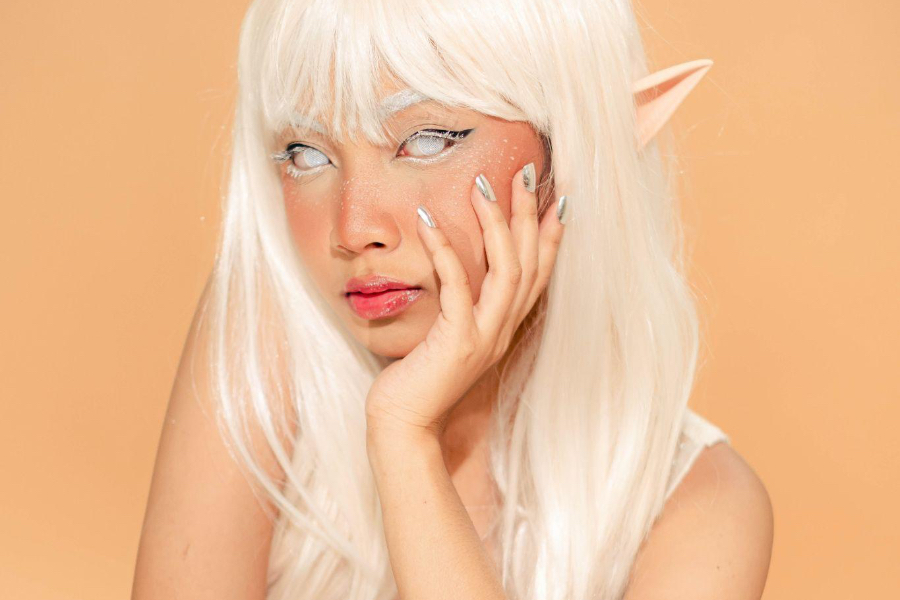 Woman dressed as elf with chrome nails